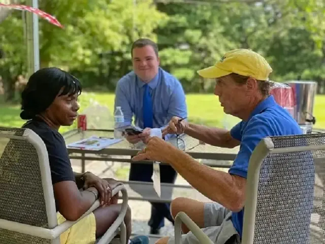Volunteers talking at an outdoor table